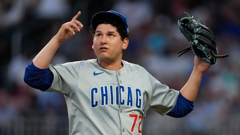 Chicago Cubs pitcher Javier Assad reacts after getting the final...