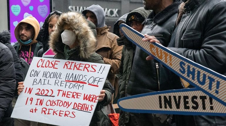 People protest outside of New York state governor Kathy Hochul's...