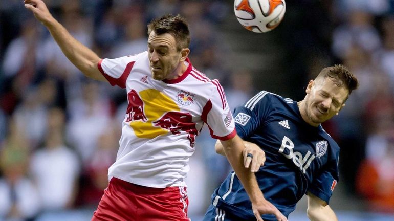 Red Bulls' Eric Alexander, left, and Vancouver Whitecaps' Jordan Harvey...