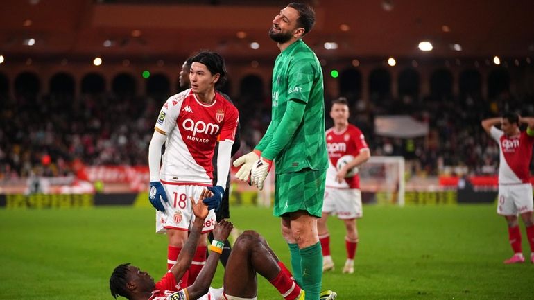 PSG's goalkeeper Gianluigi Donnarumma laughs as he stands over Monaco's...