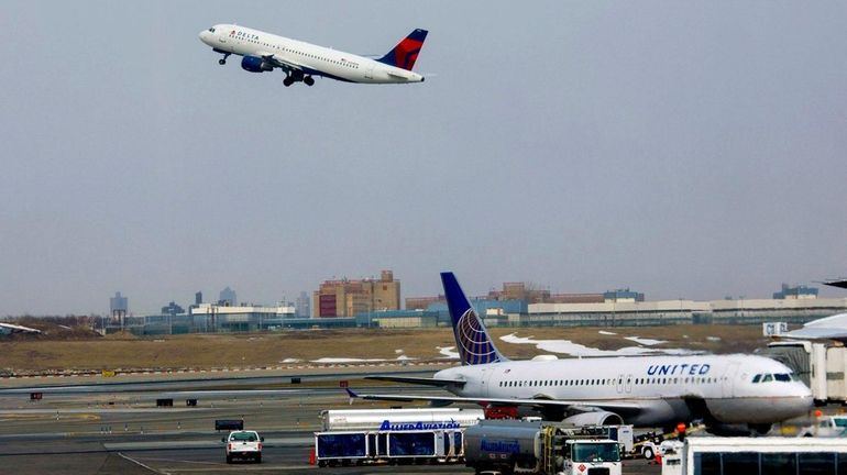 A jet lifts off from a runway at LaGuardia Airport...