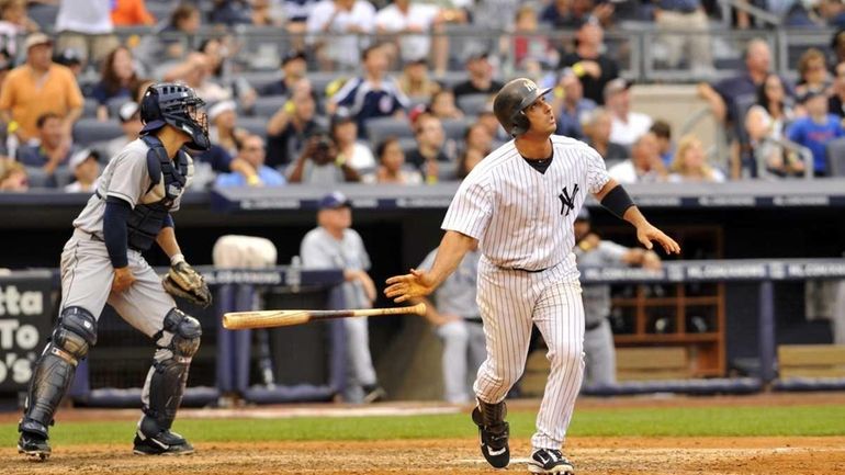 Jorge Posada follows the flight of the ball on his...