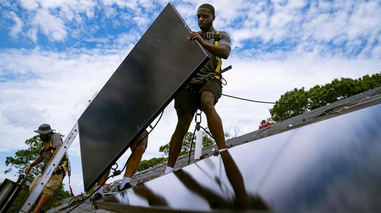 Employees of NY State Solar, a residential and commercial photovoltaic...