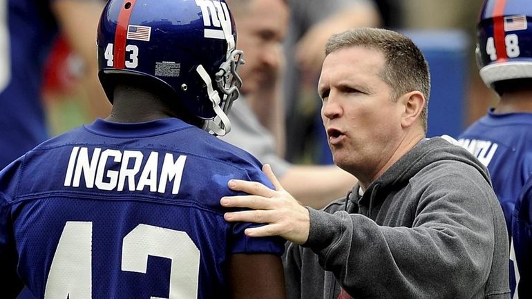 Former Giants fired defensive coordinator Bill Sheridan, right, who was...