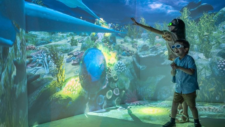 In the Four Seasons Resort Maldives' Hologram Room, family members...