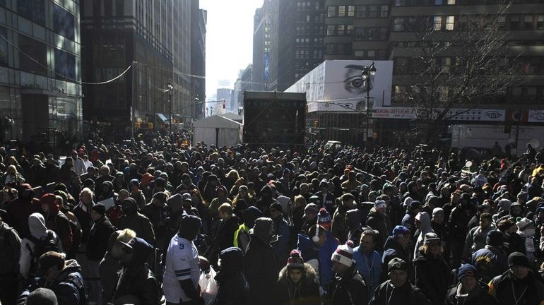 People wait in line to get autographs from NFL players...