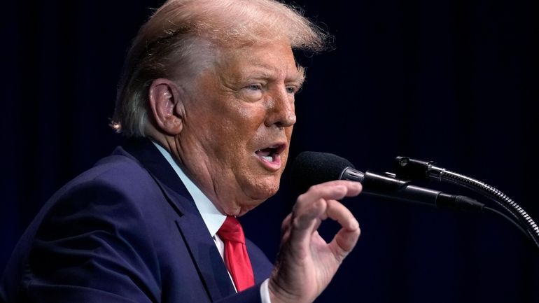 Former President Donald Trump addresses an audience during a campaign...