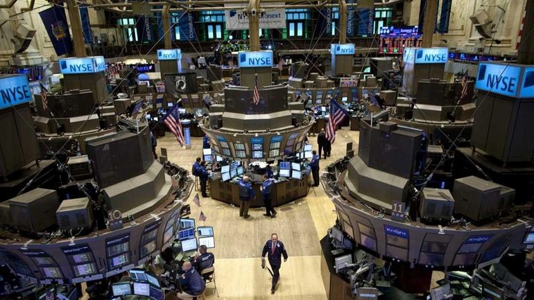 Traders work the floor of the New York Stock Exchange...