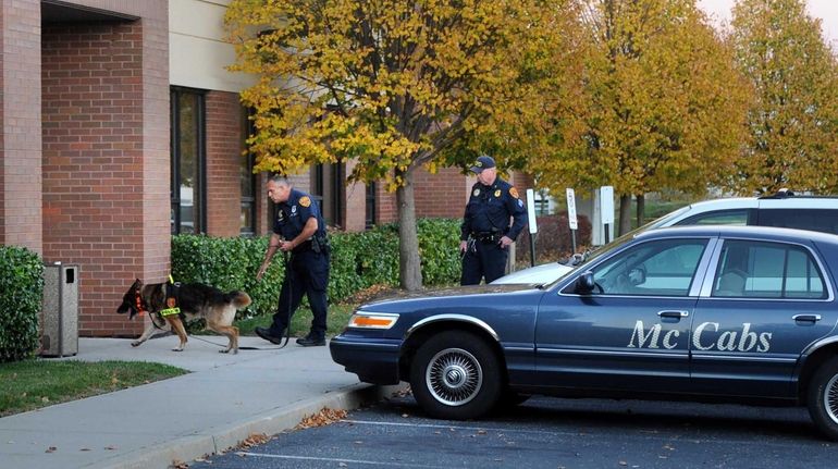 Investigators at the scene of a homicide at 606 Johnson...