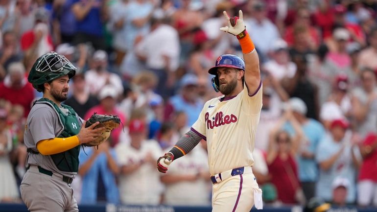 Philadelphia Phillies' Bryce Harper reacts after hitting a home run...