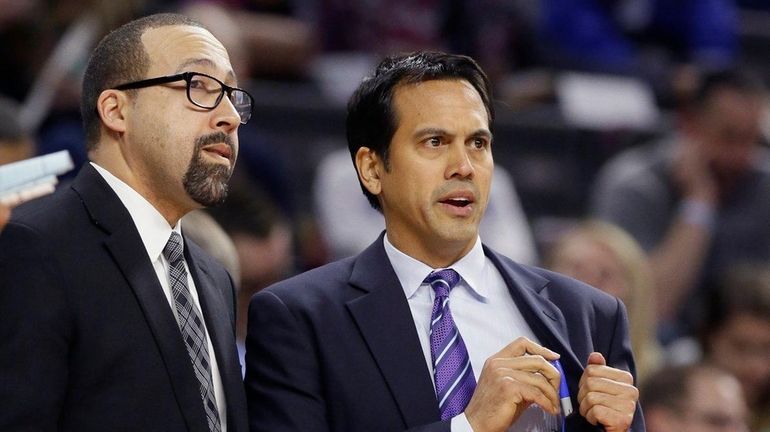 Heat head coach Erik Spoelstra, right, talks with assistant coach...