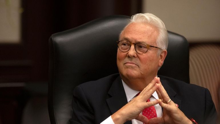 North Carolina State University Chancellor Randy Woodson listens during a...