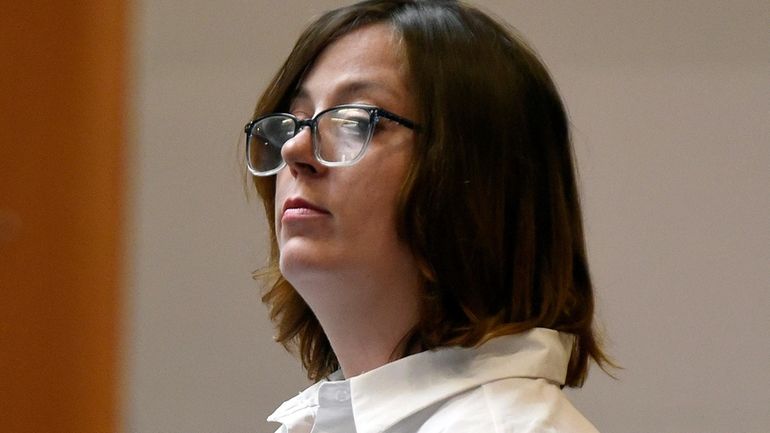 Defendant Alexandra Eckersley stands as the jury enters the courtroom...