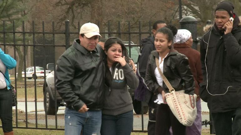 Moises Rosa walks his upset niece out of Hempstead High...