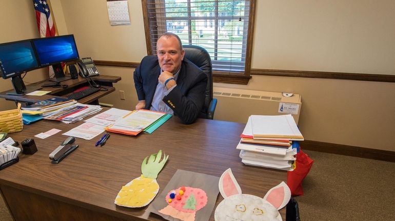 Islip Councilman James O'Connor displays artwork done by his son,...