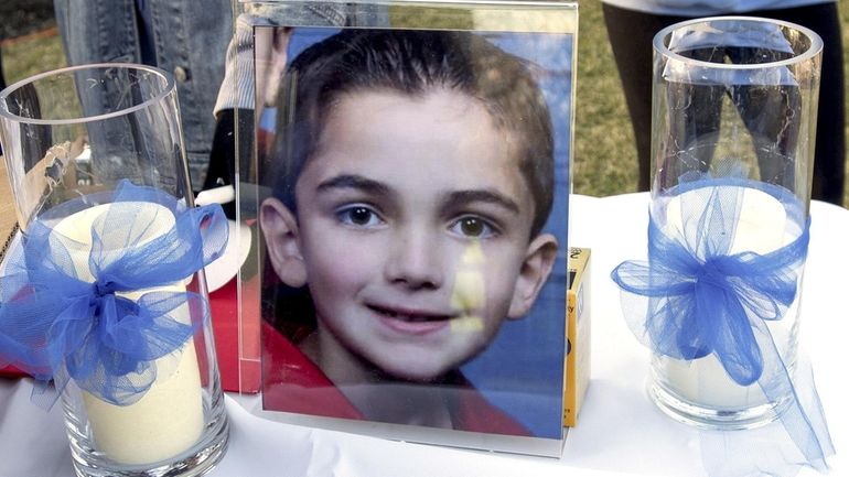 Photo of Thomas Valva is next to candles during a...