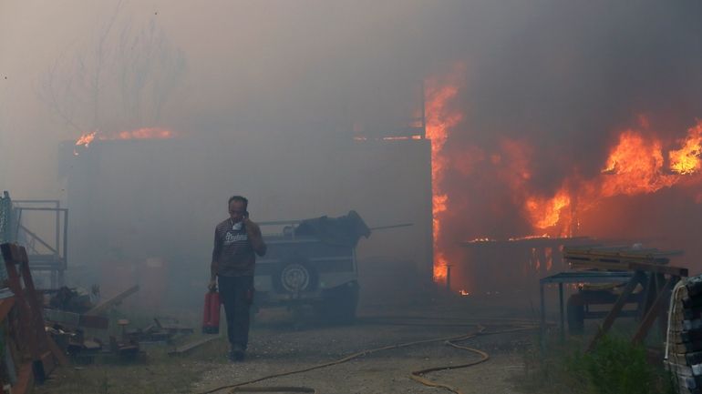 A man carries a fire extinguisher and seeks on the...