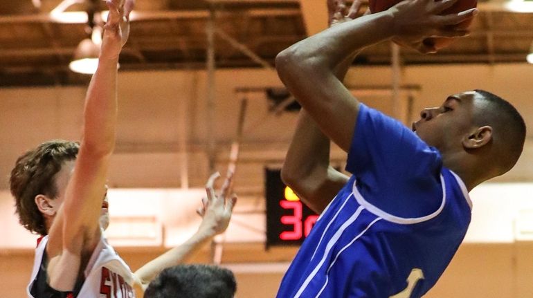 Calhoun's Corey Jones takes the shot over Syosset's Robert Kula...