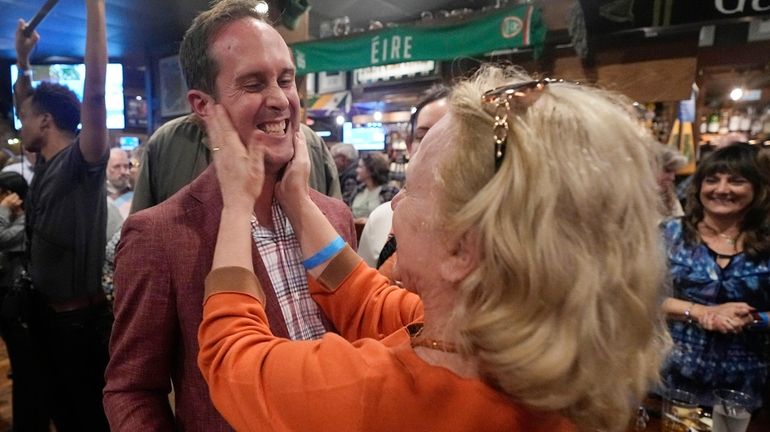 Del. Schuyler VanValkenburg, left, is greeted by a supporter at...