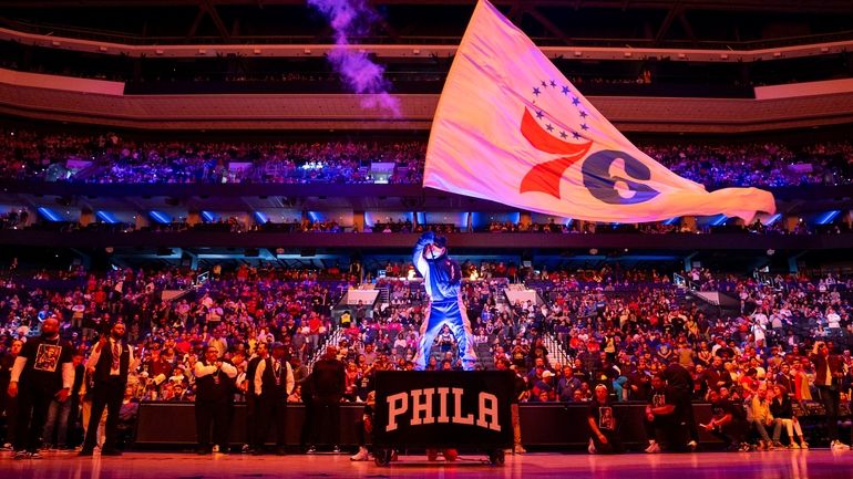 Philadelphia 76ers mascot Franklin waves the flag during pre-game introductions...