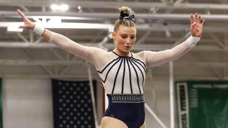 Marisa Schlossman of Plainview-Old Bethpage JFK competes on the beam...