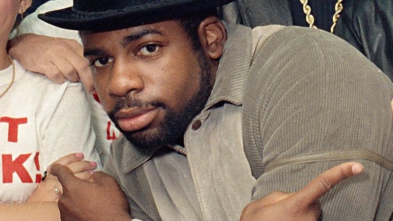 FILE -Run-D.M.C.'s Jason Mizell, Jam-Master Jay, poses with teenagers gathered...