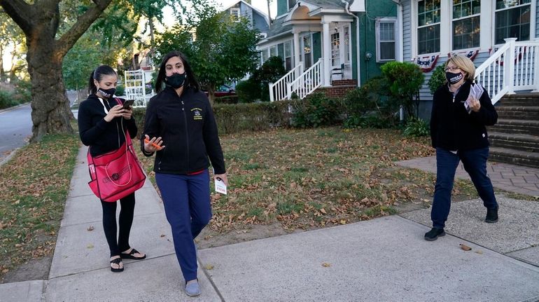 Republican Assemb. Nicole Malliotakis, center, with a campaign worker, left,...