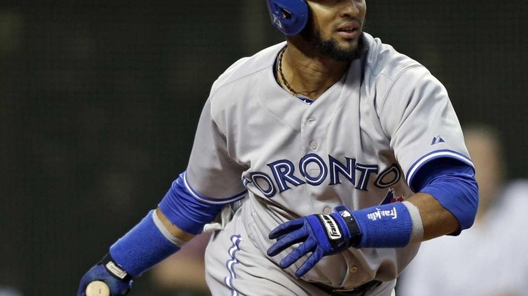 The Toronto Blue Jays' Emilio Bonifacio singles with the bases...