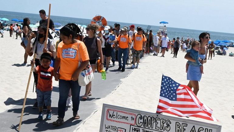 Members of the Shinnecock Nation and their allies rally at...