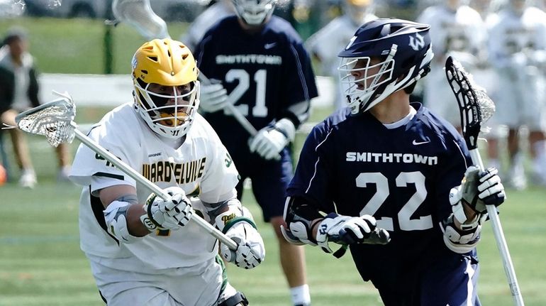 Smithown West's John Hoffman (22) drives against a Ward Melville...