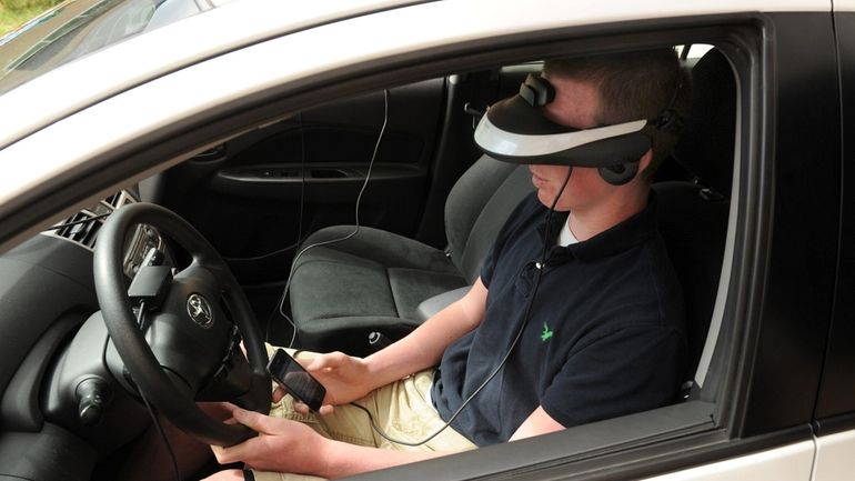 Wearing a headset that projects a street scene, Tyler Hagedorn,...