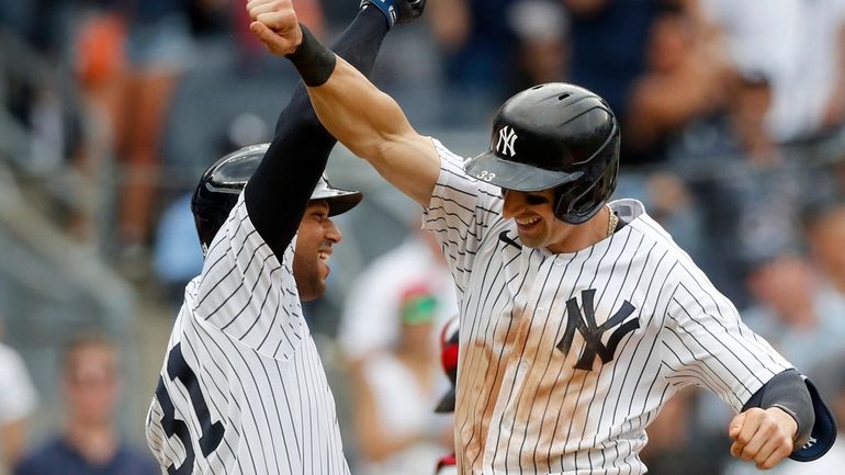 Tim Locastro #33 of the New York Yankees celebrates his...