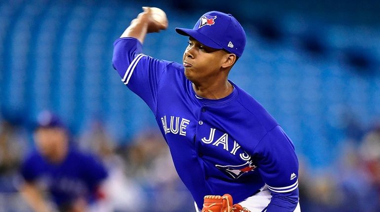 Toronto Blue Jays relief pitcher Elvis Luciano (65) works against...