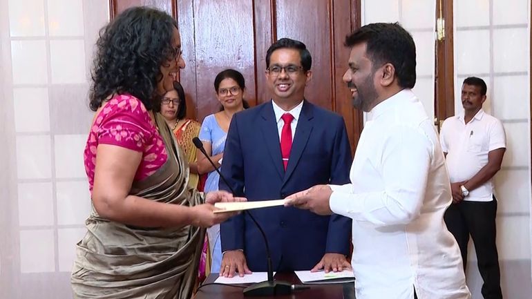 National People's power lawmaker Harini Amarasuriya, 54, left, takes oath...