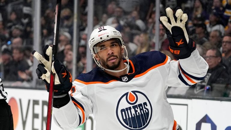 FILE - Edmonton Oilers left wing Evander Kane gestures after...