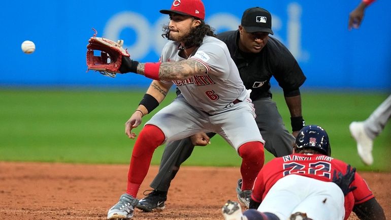 Cincinnati Reds second baseman Jonathan India, left, gets the throw...