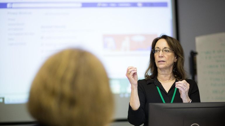 Jeri Usbay leads a SeniorNet Facebook Basics class at the...