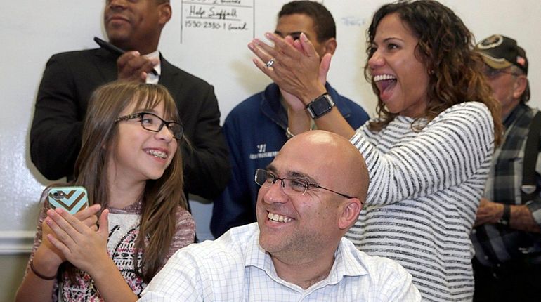 Candidate Larry Zacarese is flanked by daughter Lourdes, 11, and...