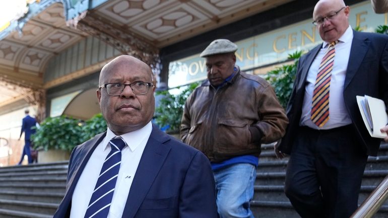 Papua New Guinea's former Petroleum Minister Jimmy Maladina, left, leaves...