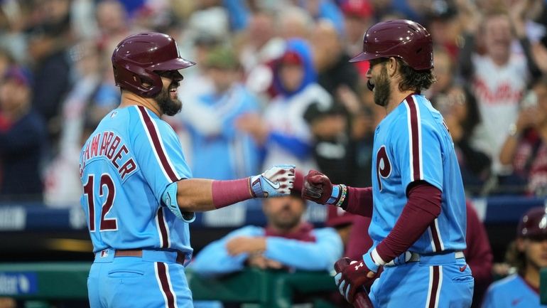 Philadelphia Phillies' Kyle Schwarber, left, celebrates his home run off...