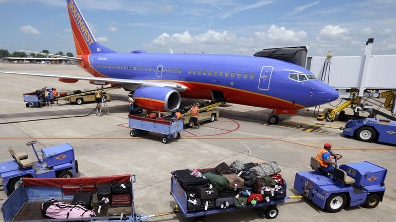 In this June 19, 2014 file photo, baggage carts are...