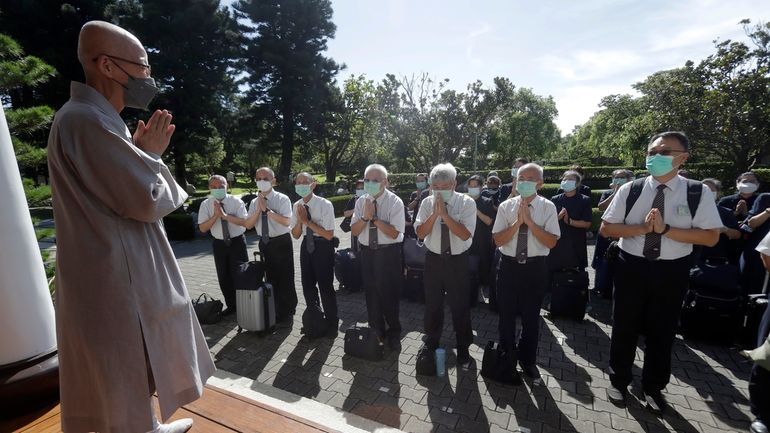 Tzu Chi volunteers say goodbye to a Buddhist master before...