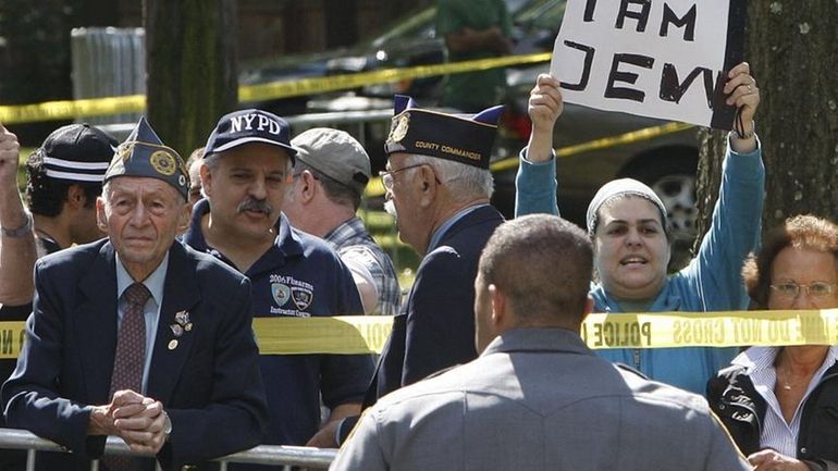 People gather Friday on East Shore Road to protest a...