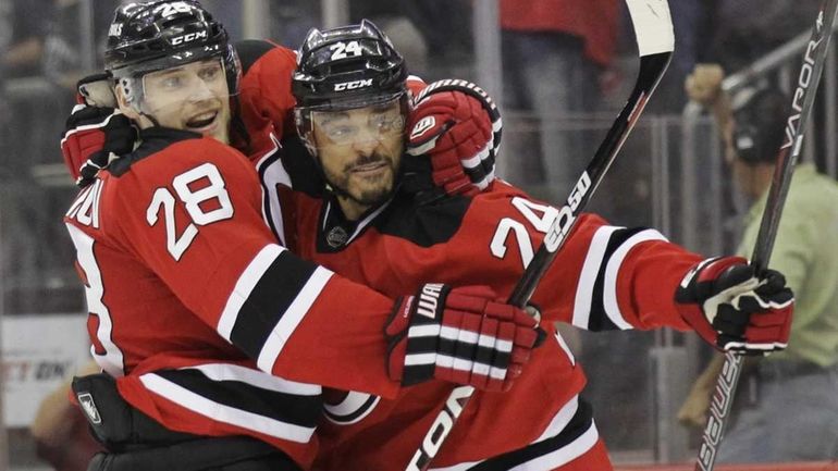 New Jersey Devils' Bryce Salvador, right, celebrates with Anton Volchenkov,...