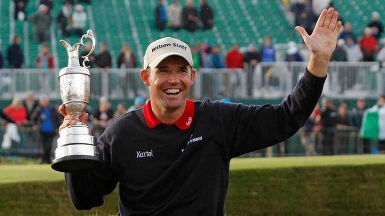 Ireland's Padraig Harrington holds the trophy after winning the British...