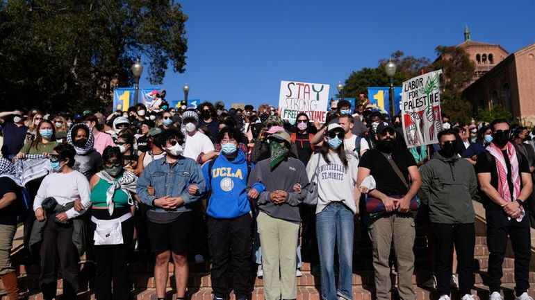 Demonstrators lock arms on the UCLA campus, after nighttime clashes...