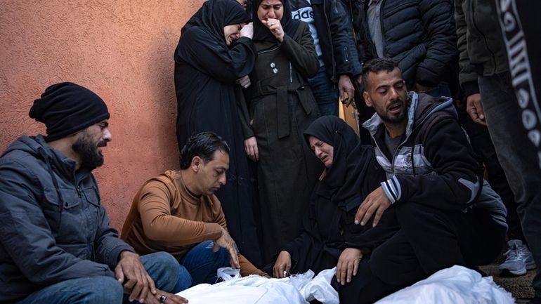 Palestinians mourn their relatives killed in the Israeli bombardment of...