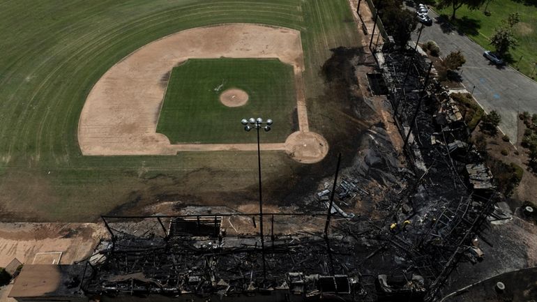 An aerial view shows the aftermath of a fire at...