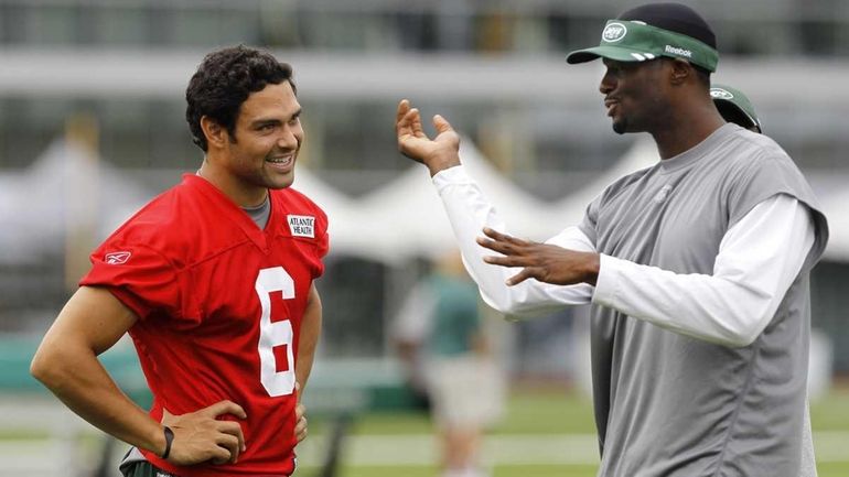 New York Jets quarterback Mark Sanchez, left, talks to wide...