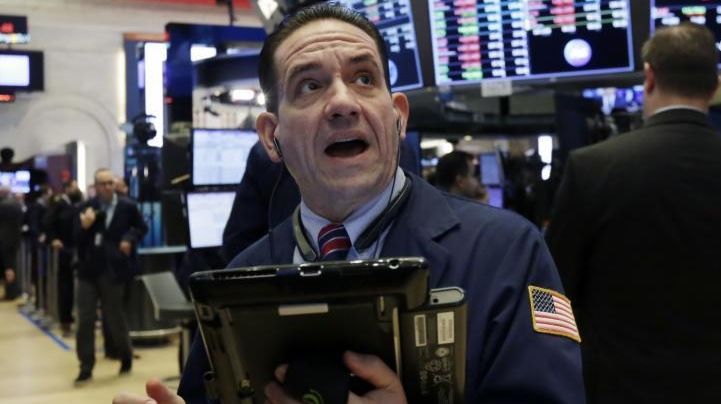 Trader Tommy Kalikas works on the floor of the NYSE,...